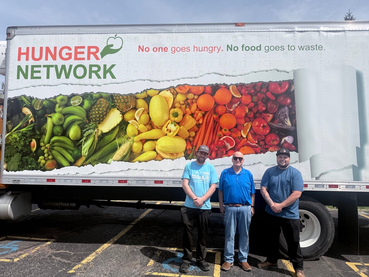 A community moment beside a Hunger Network truck
